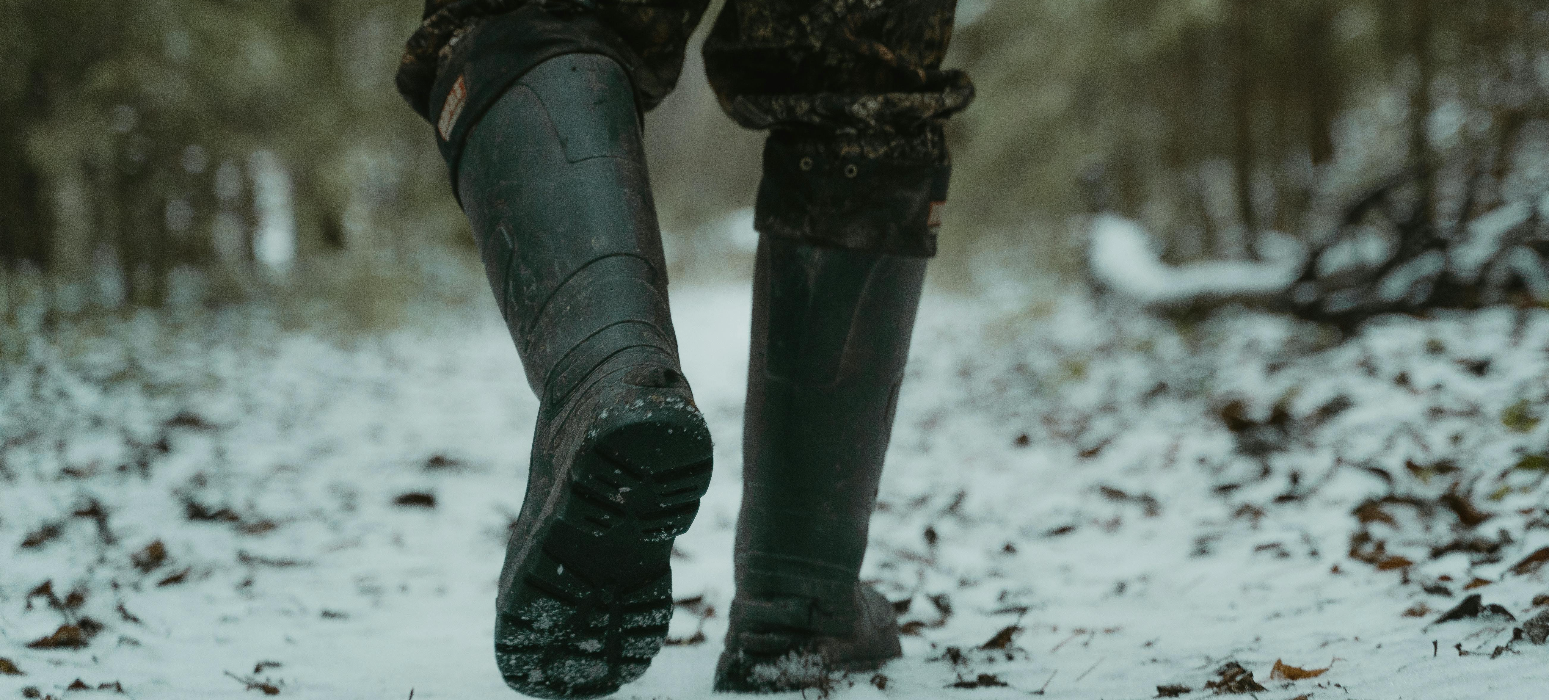 A person walking in cold weather with foot warmers in their boots