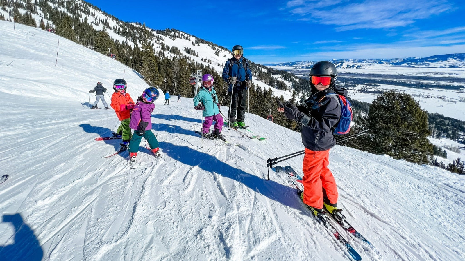 Kids on a mountain skiing with hand warmers