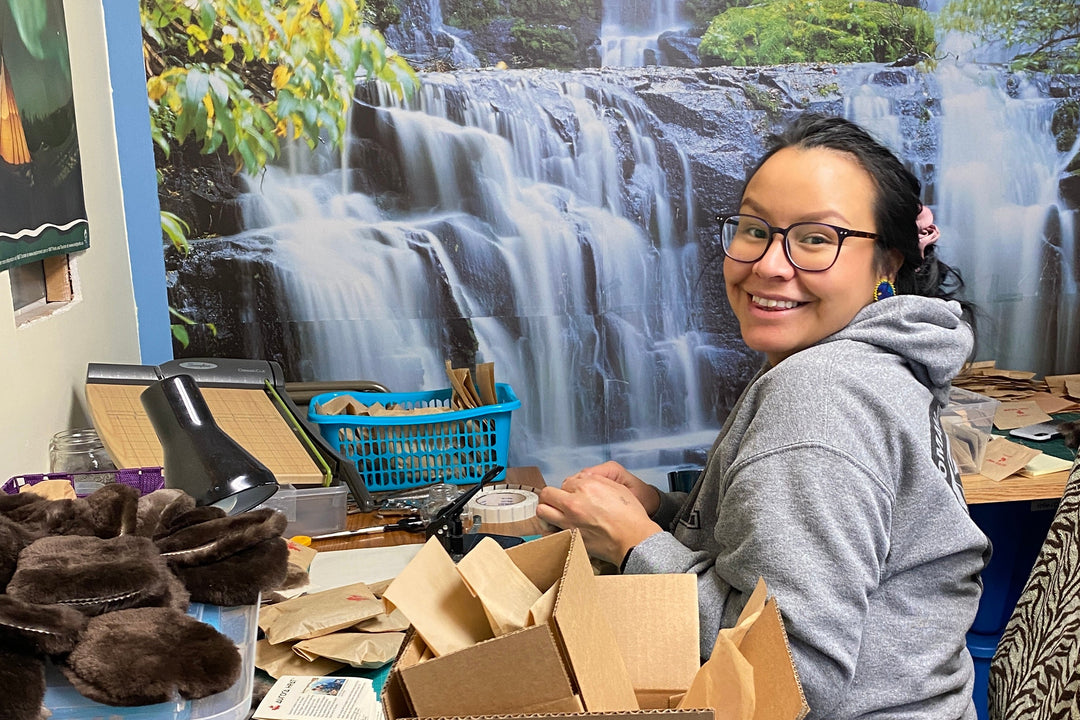 Aurora Heat employee sitting at the office with boxes and orders around